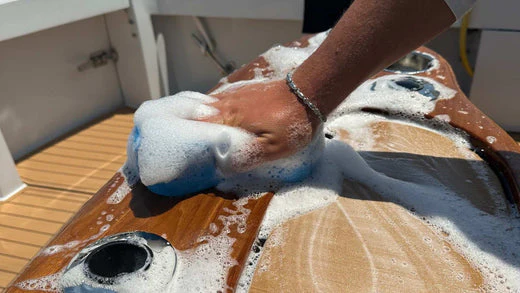 Cole Willis hand-polishing a boat hull